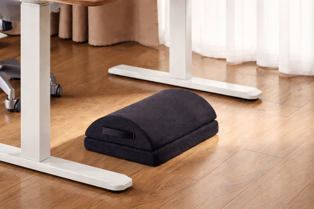 ergonomic foot rest placed under a standing desk to improve posture and comfort
